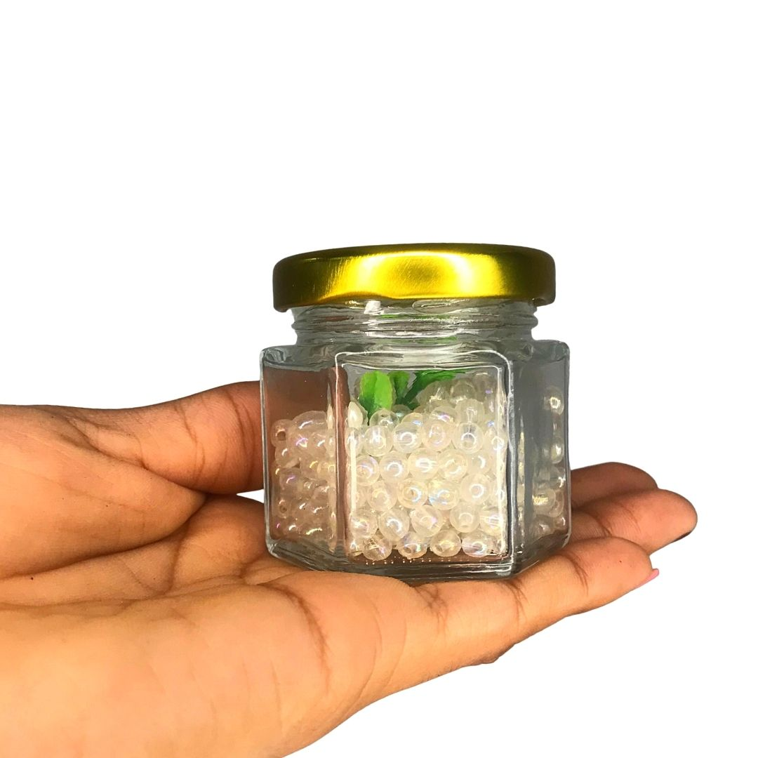 Frasco de vidrio hexagonal con tapa dorado