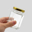 Frasco de vidrio hexagonal con tapa dorado